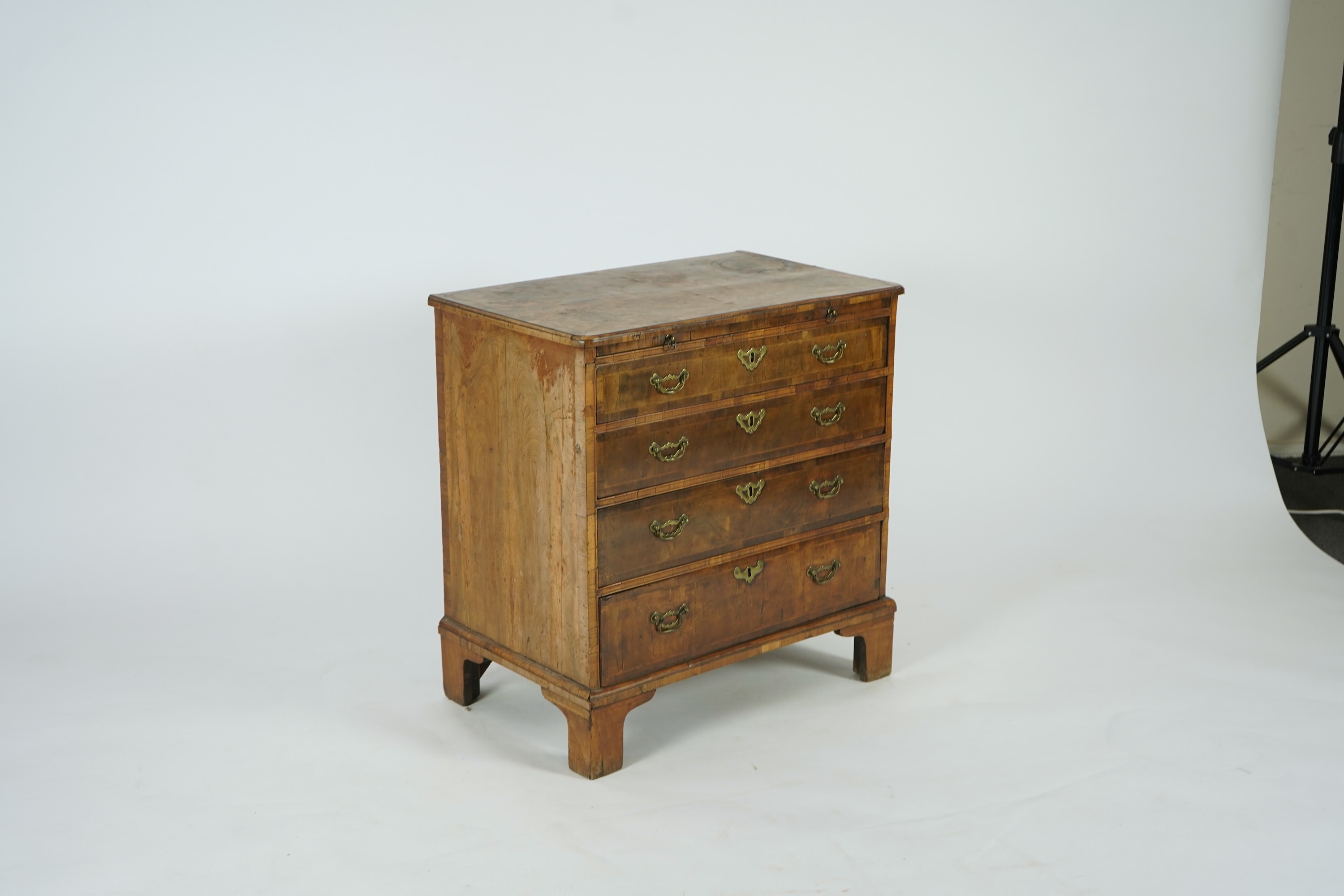 A small George I feather banded walnut chest